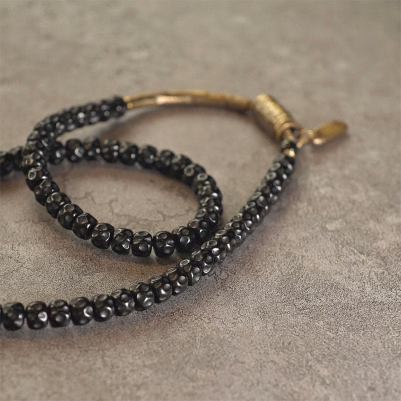Bracelet spirituel triple tour en cuivre et coquille de noix de coco