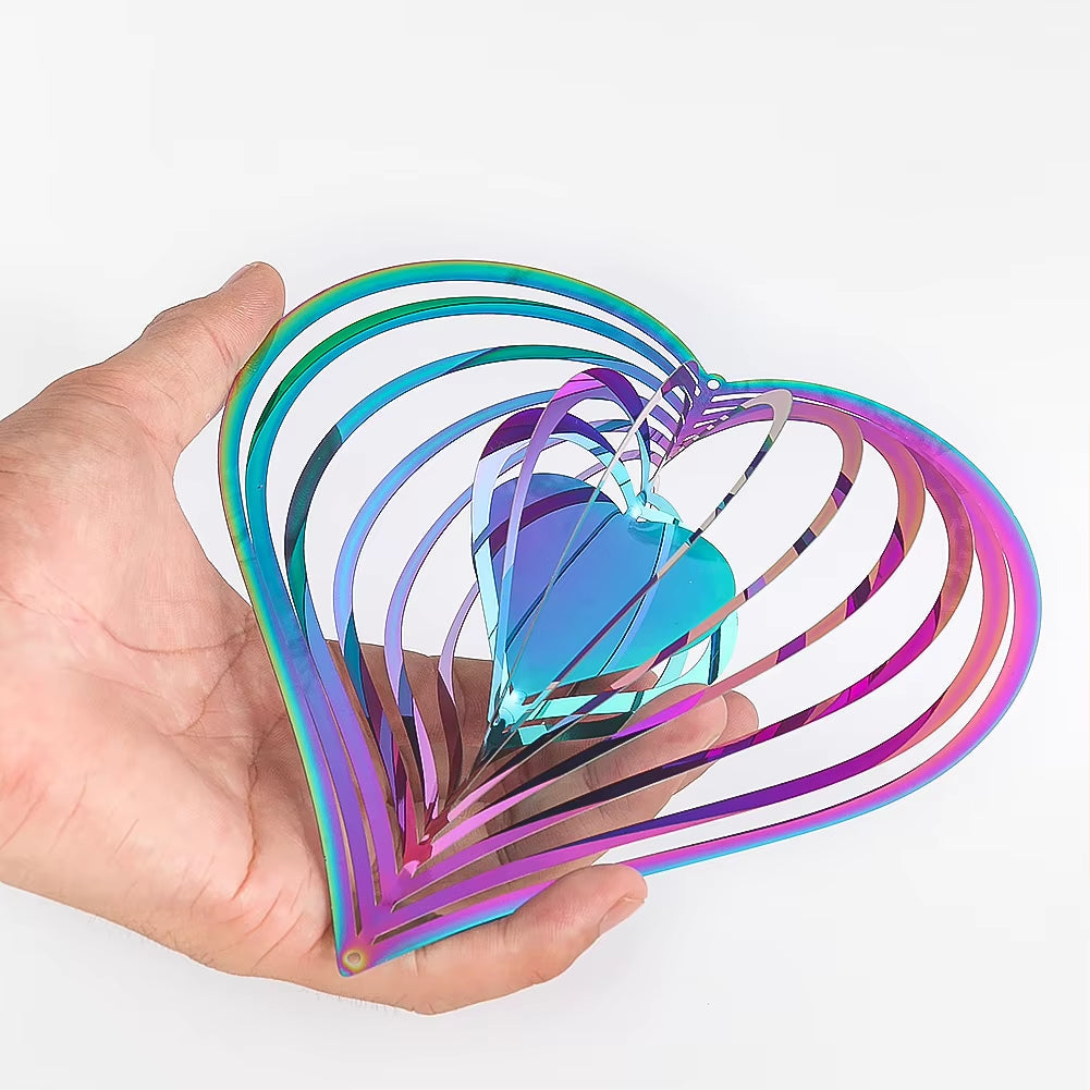 Iridescent metallic heart-shaped spiral ornament in a hand for garden decor