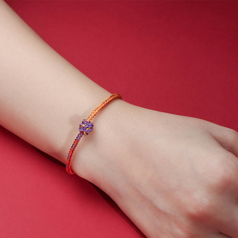 Bracelet en corde tressée colorée violette, dorée et rouge pour l'équilibre