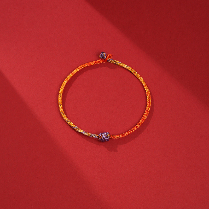 Bracelet en corde tressée colorée violette, dorée et rouge pour l'équilibre