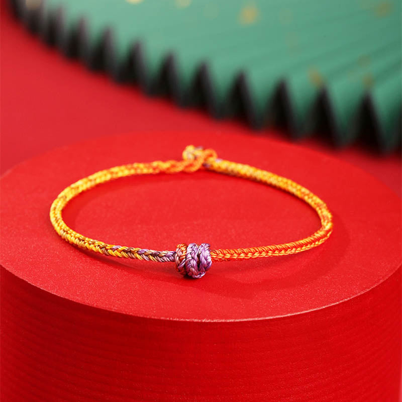 Bracelet en corde tressée colorée violette, dorée et rouge pour l'équilibre