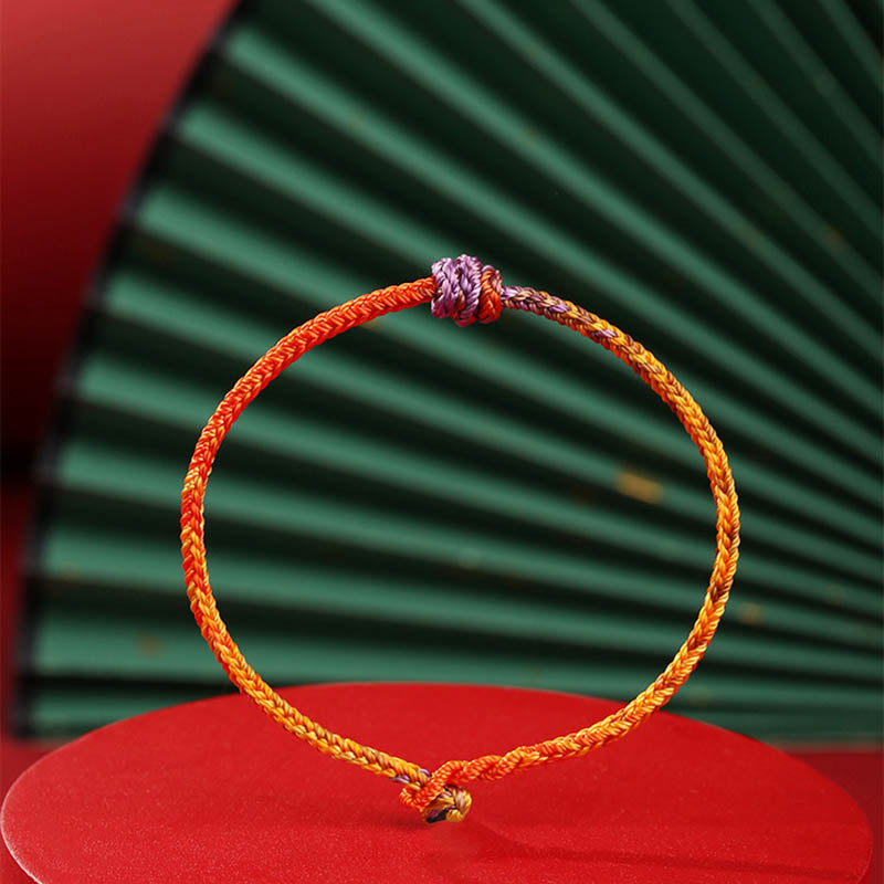 Bracelet en corde tressée colorée violette, dorée et rouge pour l'équilibre