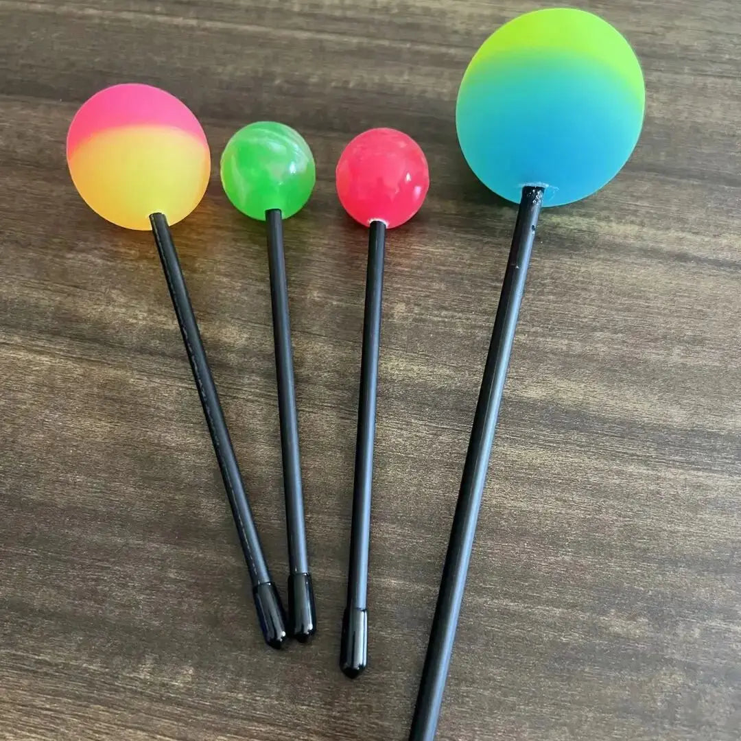 Four colorful ball-tipped percussion mallets with black handles for sound gongs