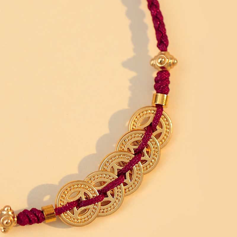 Bracelet en fil rouge avec pièce de cuivre pour la chance et la protection
