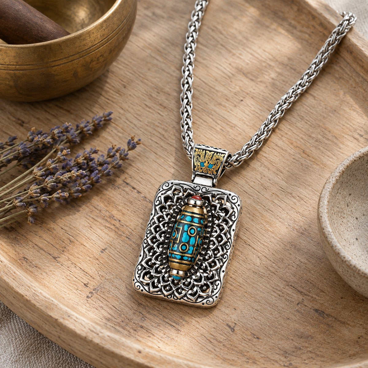 Copper Nine-Eye Dzi Bead Rotatable Protection Necklace, styled with a singing bowl and lavender