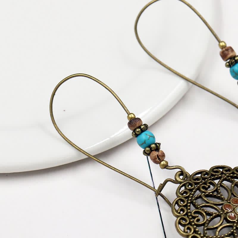 Boucles d'oreilles spirituelles en cuivre avec motif floral pour la chance et l'abondance