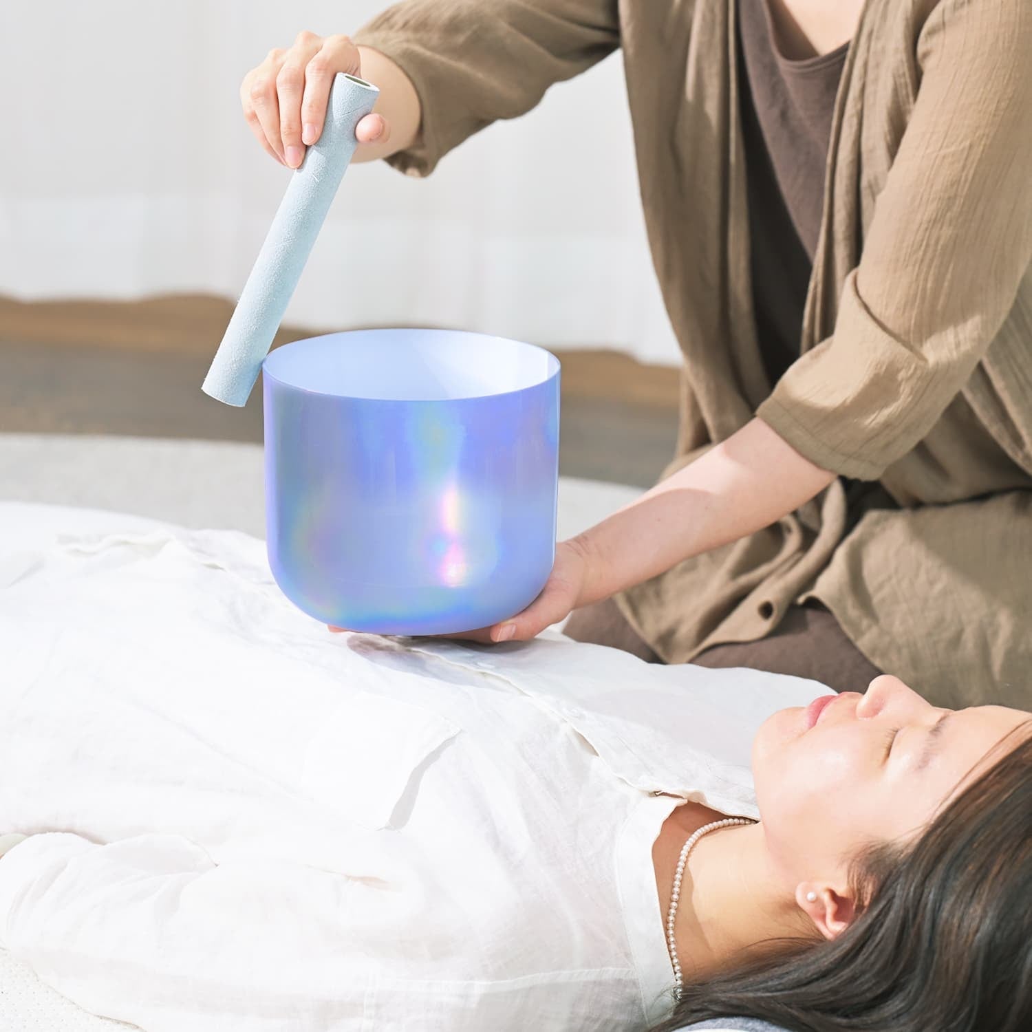 Iridescent Crystal Singing Bowl Blue Alchemy used in a sound healing session