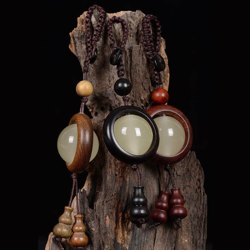 Porte-clés en bois d'ébène « Paix » | Perles lumineuses en bois de santal rouge et vert
