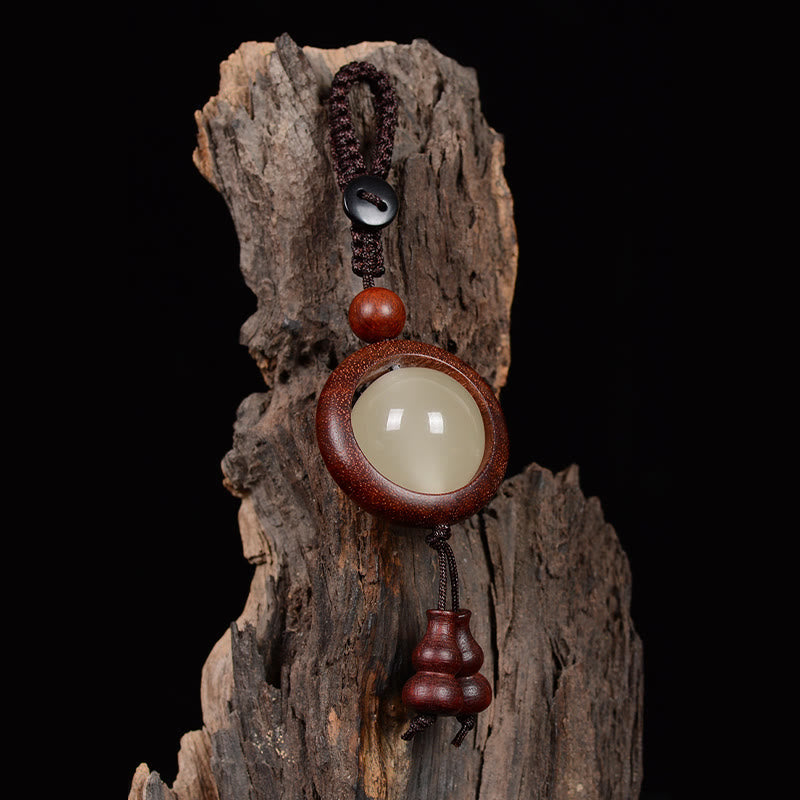 Porte-clés en bois d'ébène « Paix » | Perles lumineuses en bois de santal rouge et vert