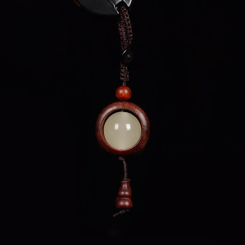 Porte-clés en bois d'ébène « Paix » | Perles lumineuses en bois de santal rouge et vert