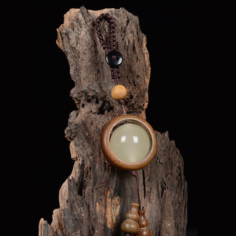 Porte-clés en bois d'ébène « Paix » | Perles lumineuses en bois de santal rouge et vert