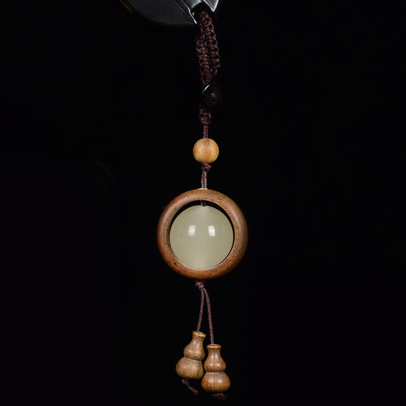 Porte-clés en bois d'ébène « Paix » | Perles lumineuses en bois de santal rouge et vert