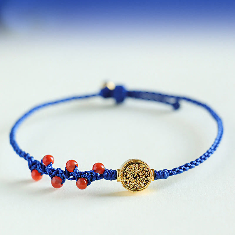 Bracelet fleur en cuivre et grenat sur fil bleu | Sons de guérison