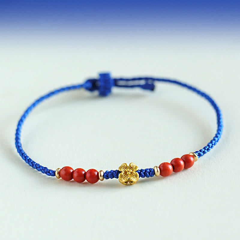 Bracelet fleur en cuivre et grenat sur fil bleu | Sons de guérison