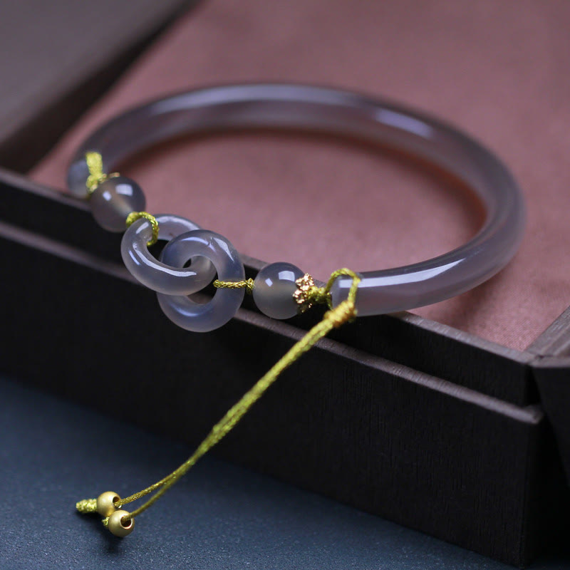 Bracelet spirituel en agate grise avec boucle de paix pour l'équilibre