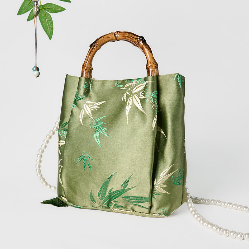 Sac bandoulière en perles avec poignée en bambou vert et broderie de feuilles