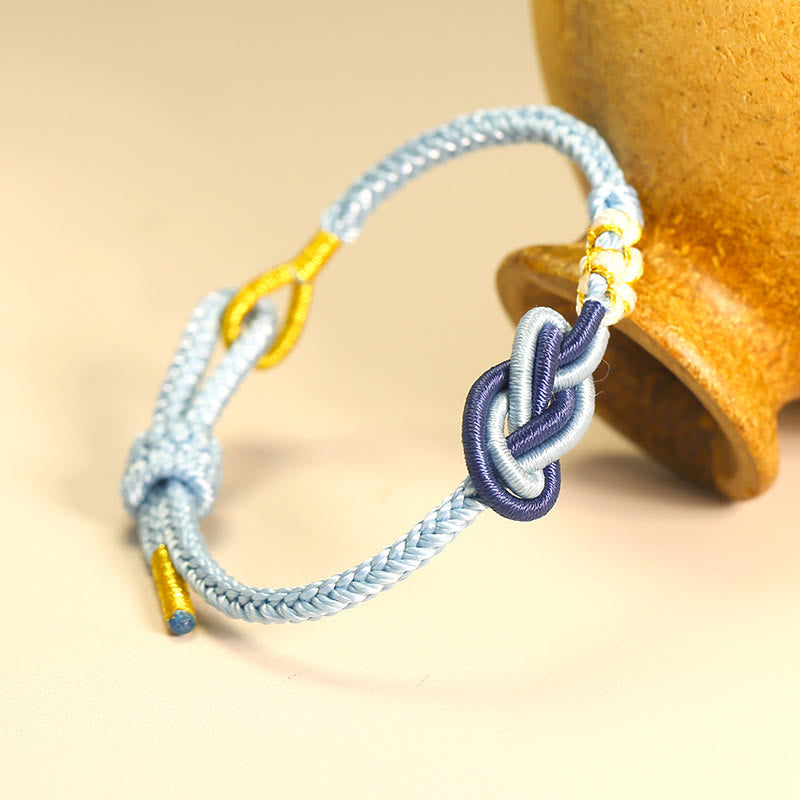 Bracelet artisanal à huit fils rouges avec nœud de paix