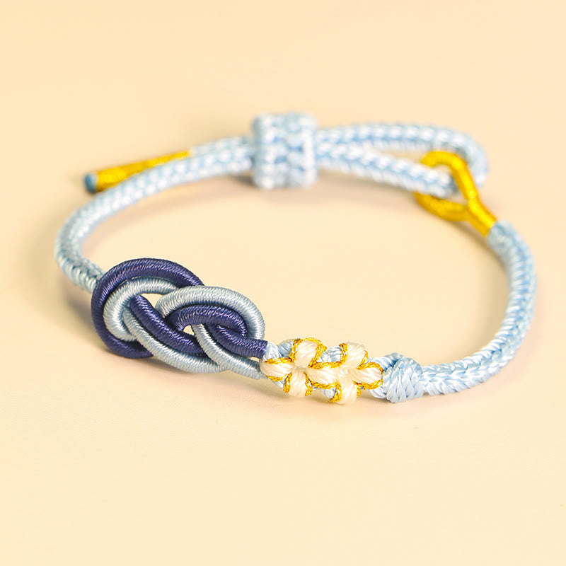 Bracelet artisanal à huit fils rouges avec nœud de paix