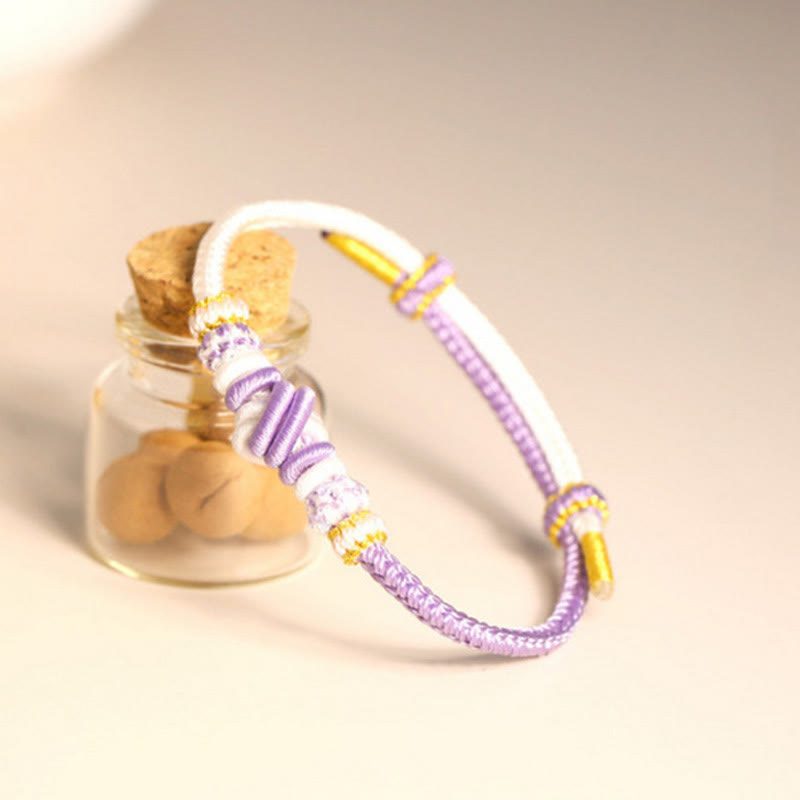 Bracelet en fil rouge bicolore avec nœud de paix fabriqué à la main