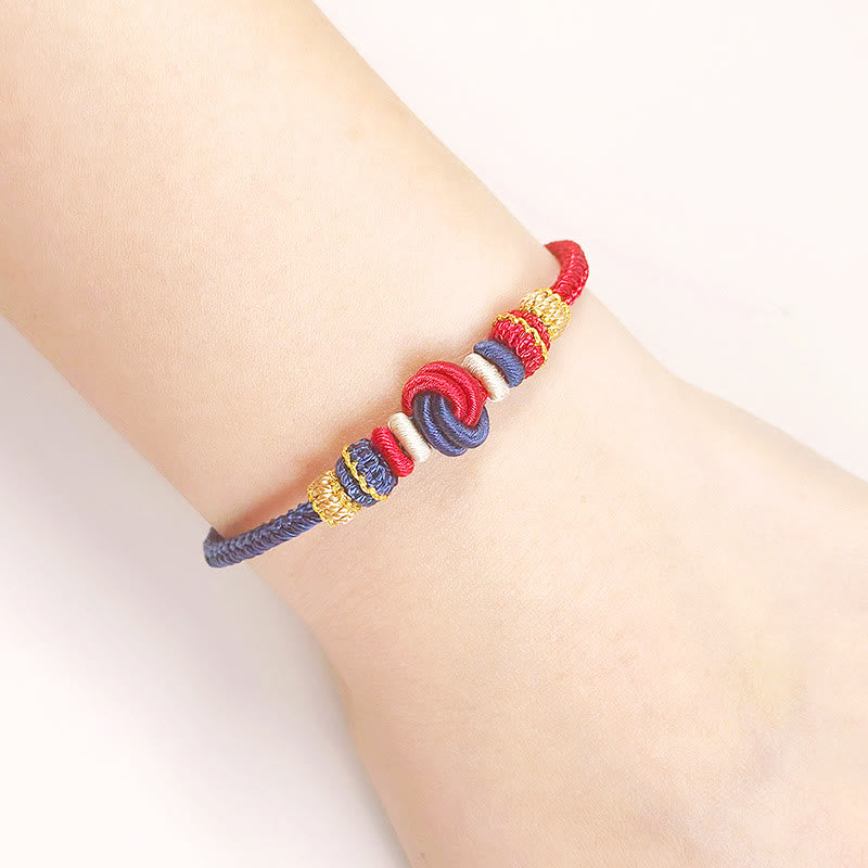 Bracelet en fil rouge bicolore avec nœud de paix fabriqué à la main