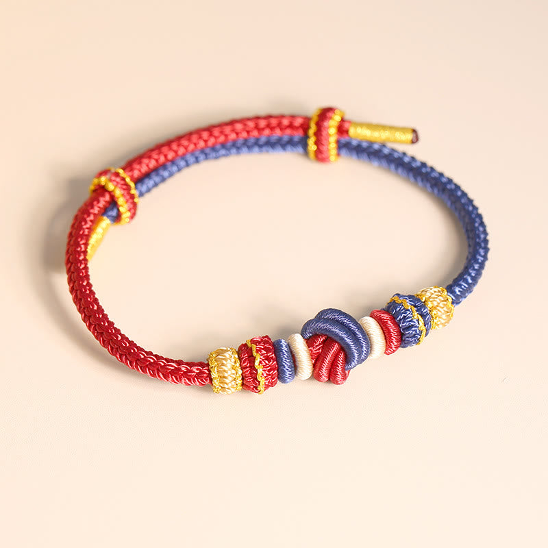 Bracelet en fil rouge bicolore avec nœud de paix fabriqué à la main