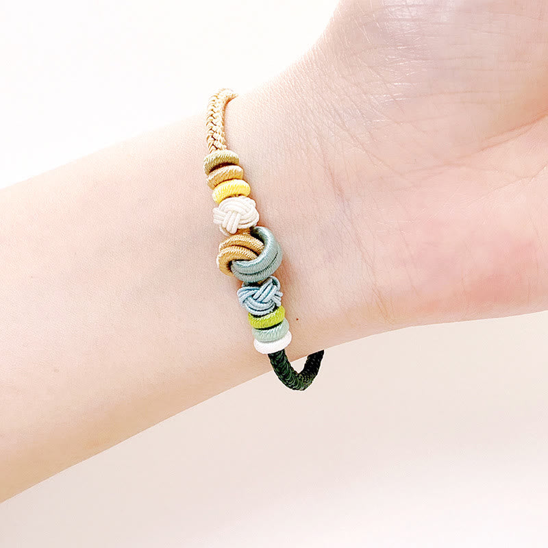 Bracelet en fil rouge bicolore avec nœud de paix fabriqué à la main