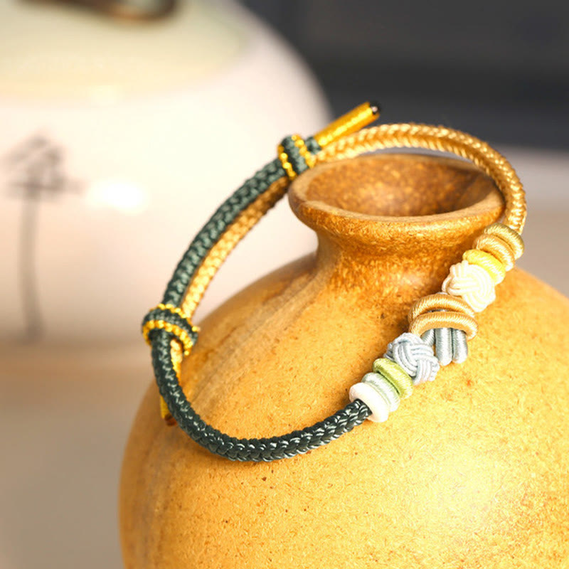 Bracelet en fil rouge bicolore avec nœud de paix fabriqué à la main