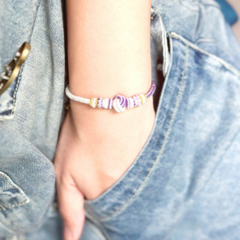 Bracelet en fil rouge bicolore avec nœud de paix fabriqué à la main