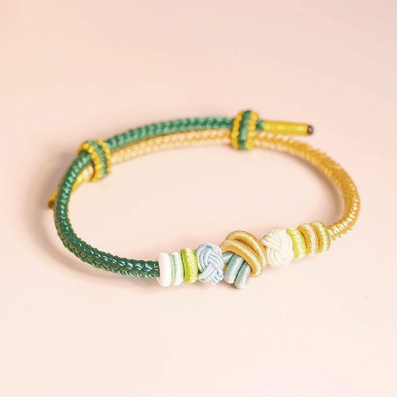 Bracelet en fil rouge bicolore avec nœud de paix fabriqué à la main