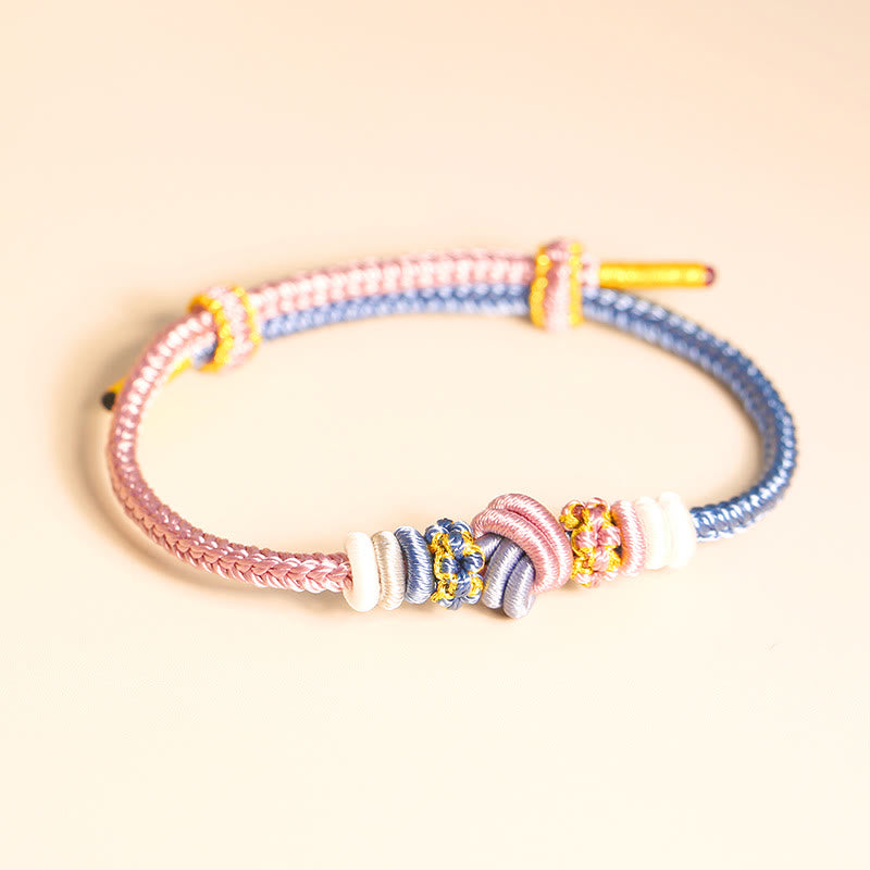 Bracelet en fil rouge bicolore avec nœud de paix fabriqué à la main