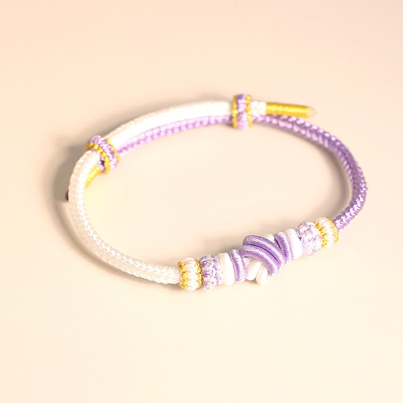 Bracelet en fil rouge bicolore avec nœud de paix fabriqué à la main