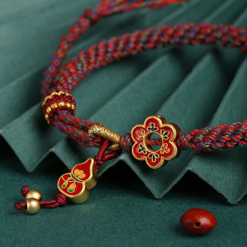 Bracelet de protection en fil rouge fait main avec fleur de courge colorée