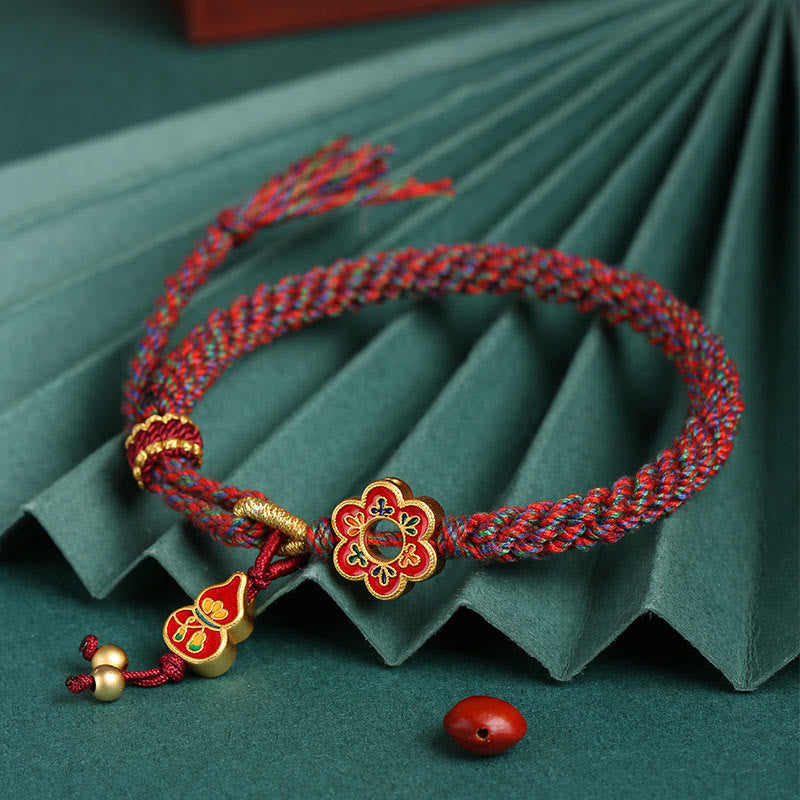 Bracelet de protection en fil rouge fait main avec fleur de courge colorée