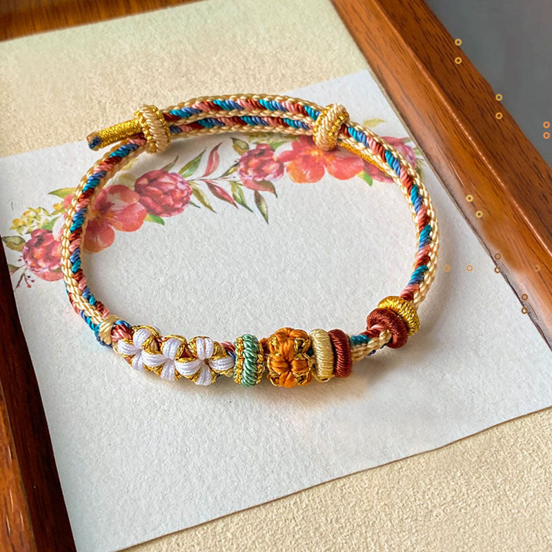 Bracelet en fil rouge à motif de fleurs de pêcher Dunhuang fait main