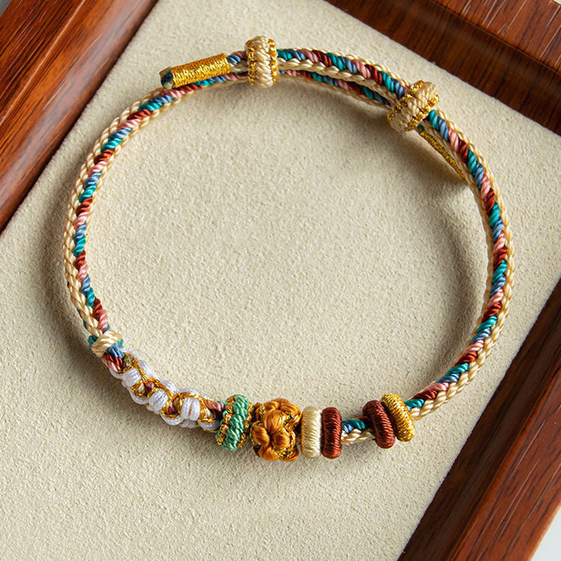 Bracelet en fil rouge à motif de fleurs de pêcher Dunhuang fait main
