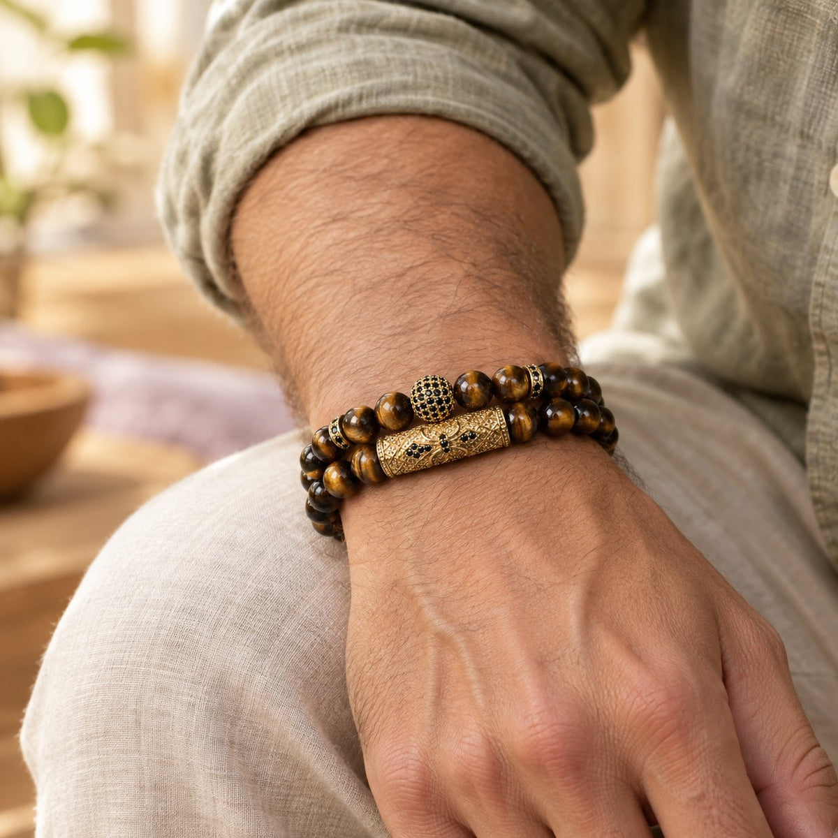 Tiger Eye & Black Agate Beaded Bracelets, worn on the wrist by a man