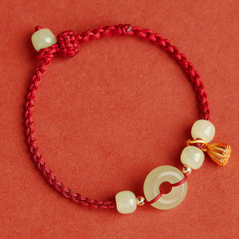 Bracelet en fil de jade et lotus de paix pour l'abondance