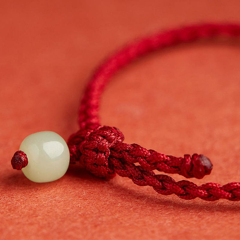 Bracelet en fil de jade et lotus de paix pour l'abondance