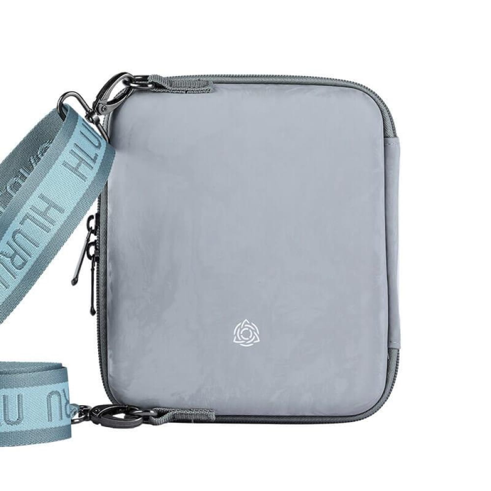 Grey crossbody bag with mint strap for Kalimba Case, featuring small logo emblem