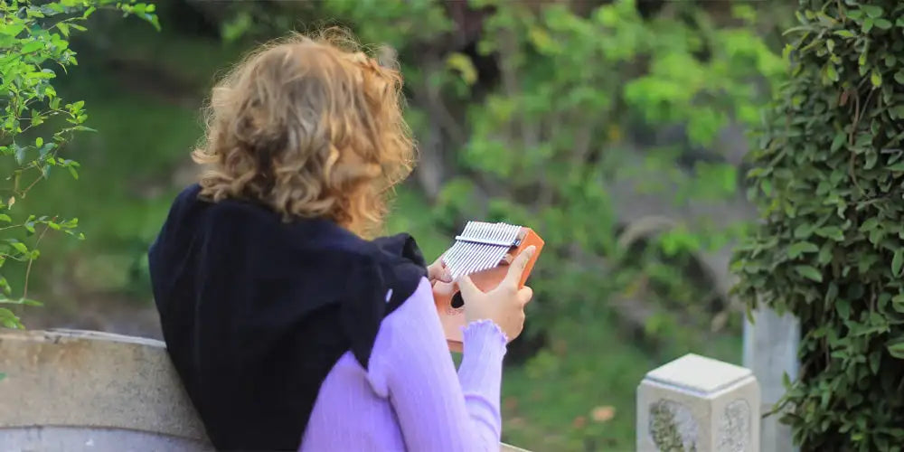 Orange wooden kalimba with silver metal keys