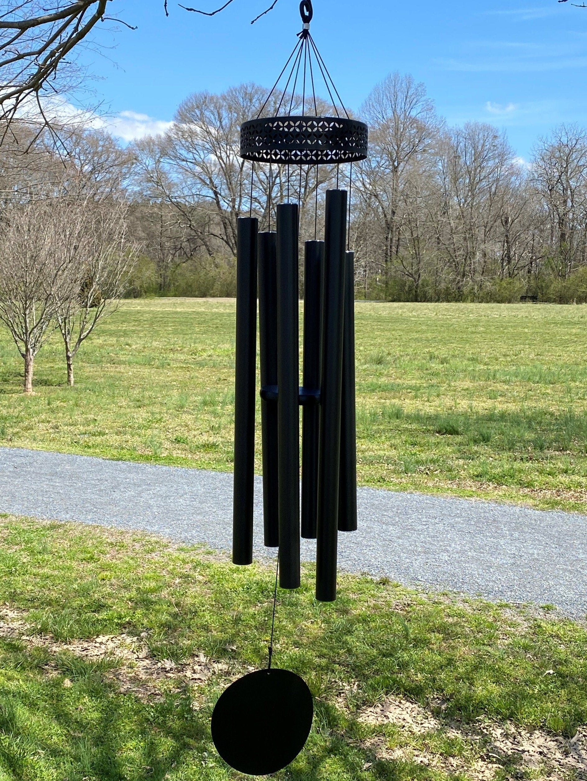 Black metal wind chimes with long tubes and decorative top for deep tones