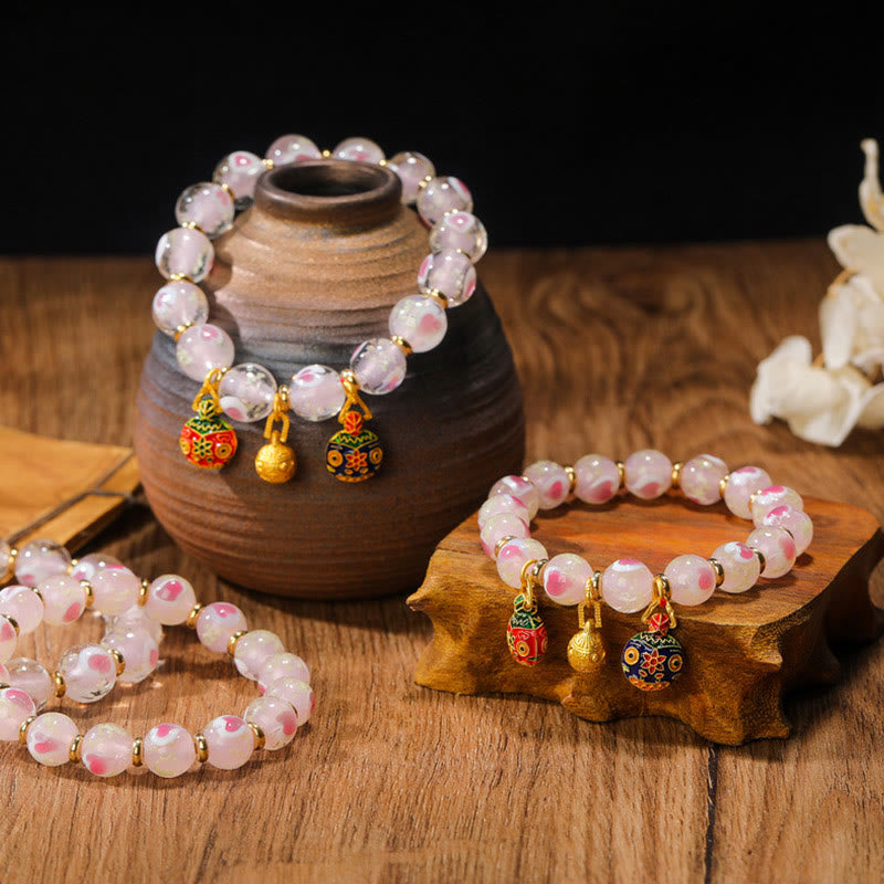 Bracelet spirituel en forme de cœur rose lumineux avec une bête avaleuse en or