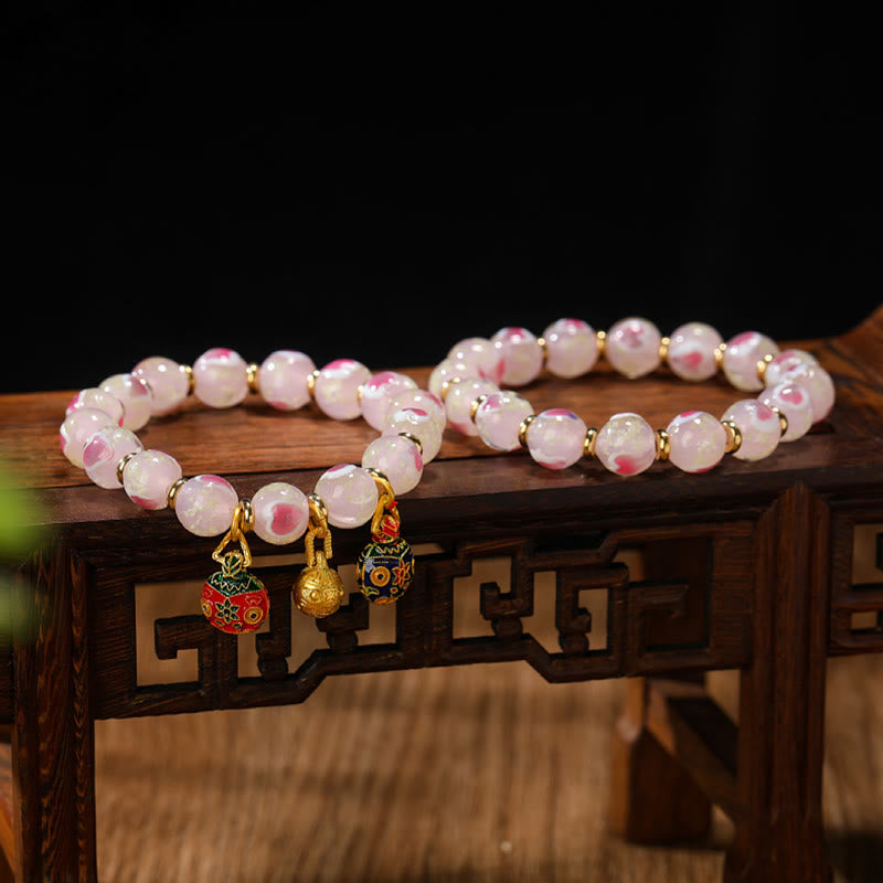 Bracelet spirituel en forme de cœur rose lumineux avec une bête avaleuse en or