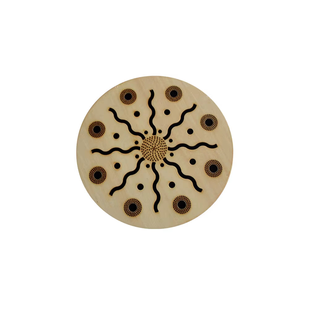 Circular beige Ocean Drum with black sunburst pattern and brown dots for meditation