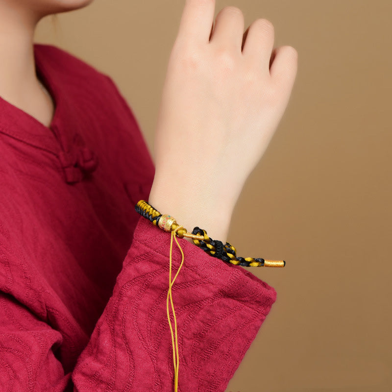 Bracelet en corde noire et or tibétain Om Mani Padme Hum