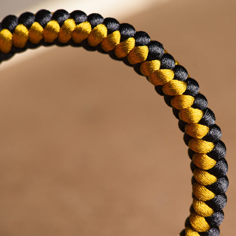 Bracelet en corde noire et or tibétain Om Mani Padme Hum