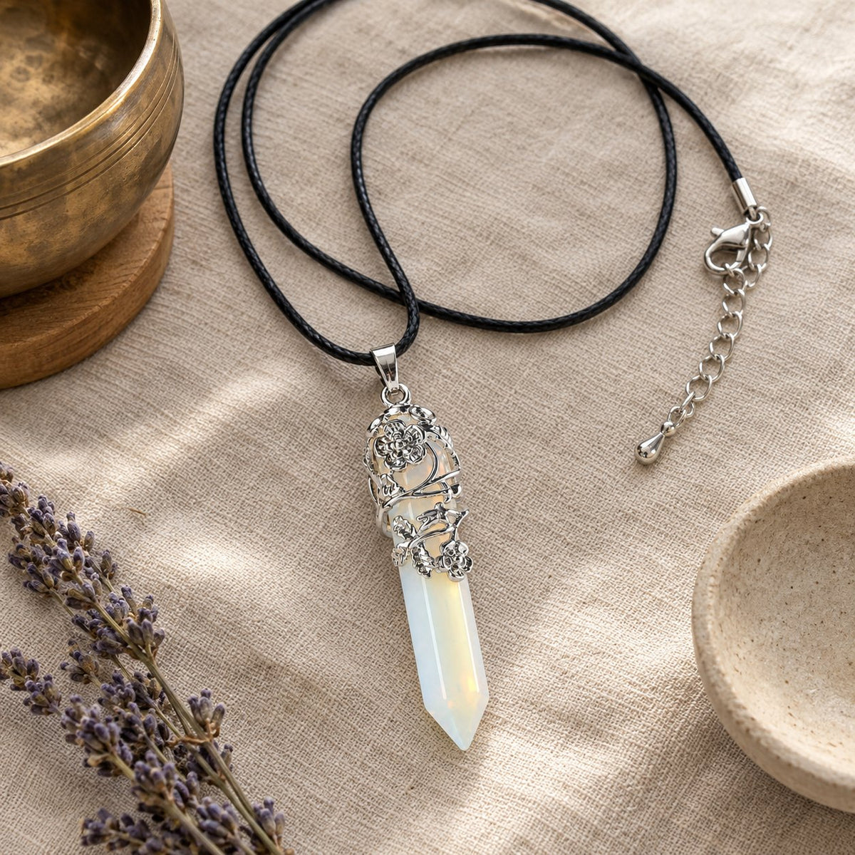 Opalite Healing Crystal Pendant for Spiritual Protection, styled with a singing bowl and lavender
