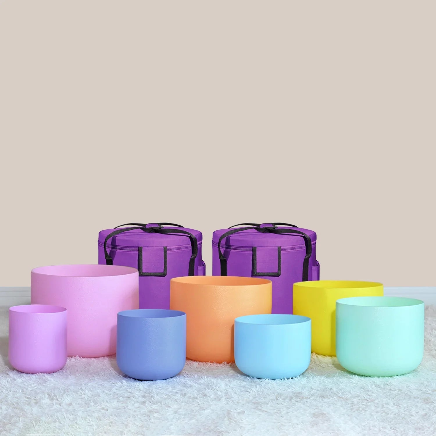 Colorful Crystal Singing Bowls in pastel rainbow with purple carrying cases for meditation