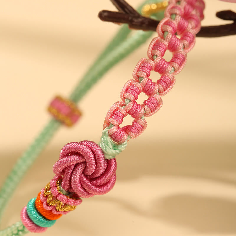 Bracelet en fil rouge avec nœud en fleur de pêcher pour la protection et l'amour