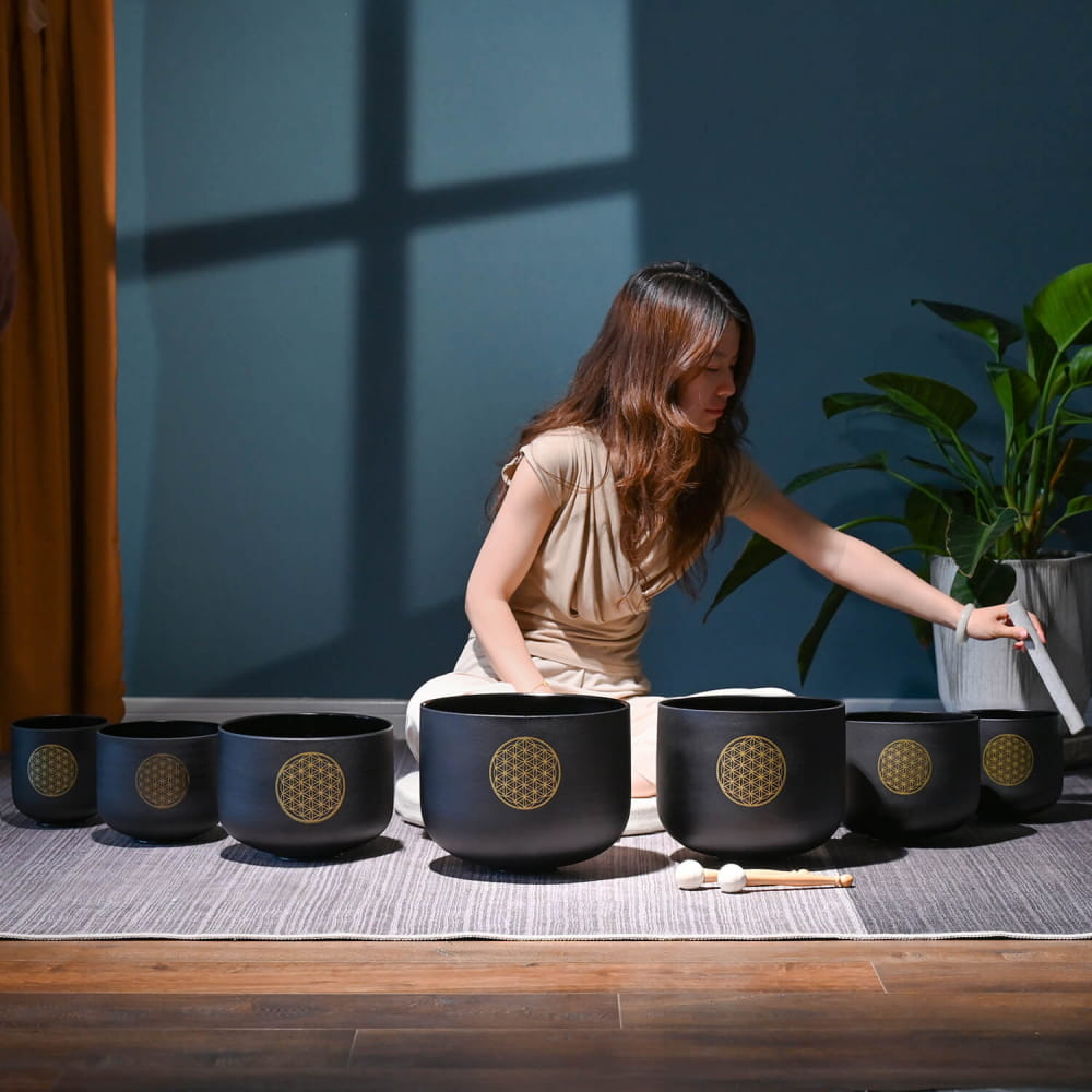 Black crystal singing bowls with golden Flower of Life symbols in a 7 PCS set